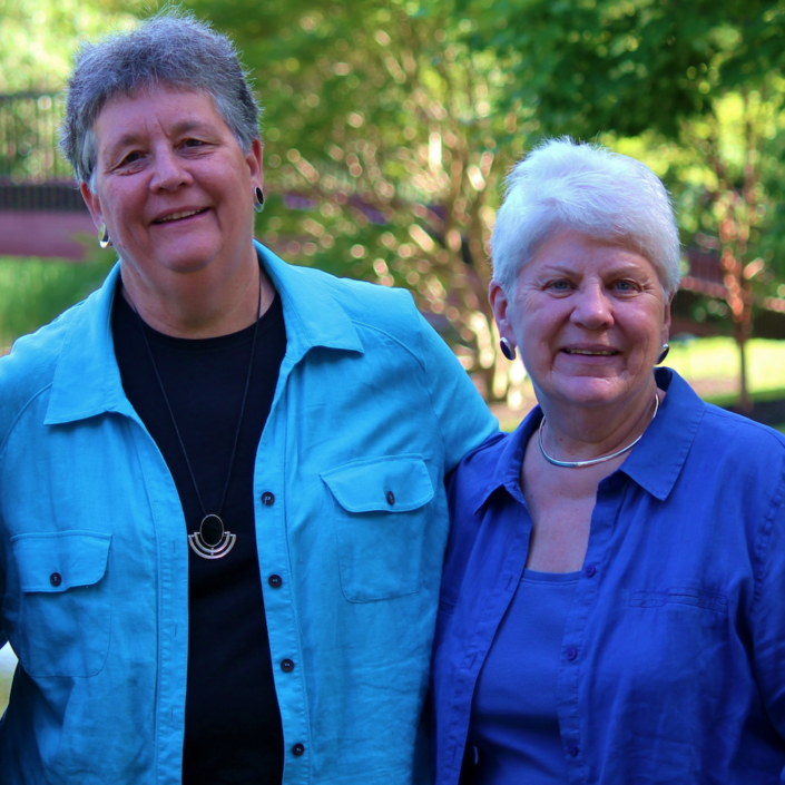 Co-founders Mary Hunt and Diann Neu, wearing blue and smiling